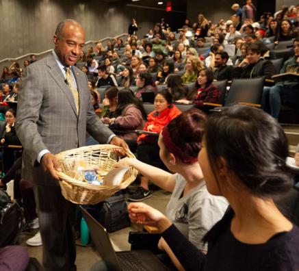 Chancellor May passes out cookies at teaching prize celebration.